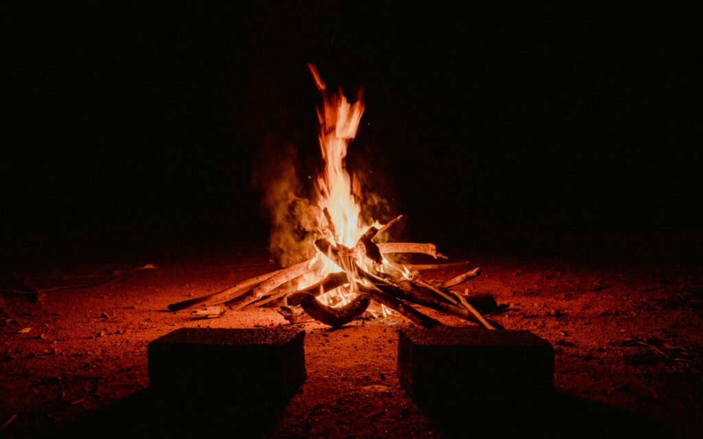 A warm campfire burning brightly against the dark night in Pedra Bela, Brazil.